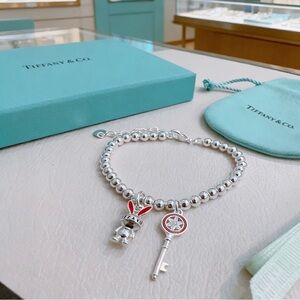 Tiffany & Co. Silver Bead Bracelet with Red-Accented Bunny and Key Charms